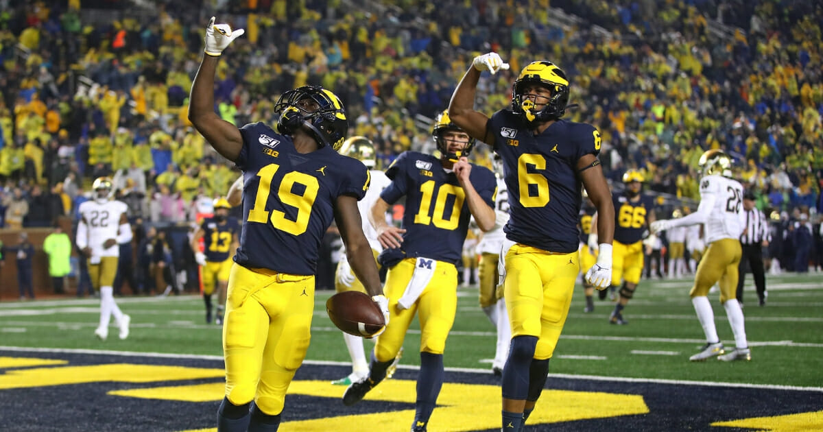 Mike Sainristil #19 of the Michigan Wolverines celebrates his second half touchdown with teammates while playing against the Notre Dame Fighting Irish at Michigan Stadium on Oct. 26, 2019, in Ann Arbor, Michigan.