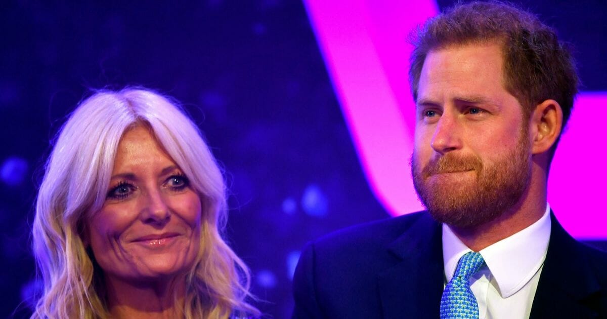 Prince Harry, Duke of Sussex reacts next to television presenter Gaby Roslin as he delivers a speech during the WellChild Awards at Royal Lancaster Hotel on Oct. 15, 2019, in London, England.
