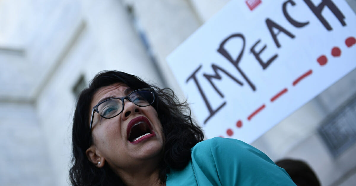Democratic Rep. Rashida Tlaib of Michigan joins activists calling for the impeachment of President Donald Trump.