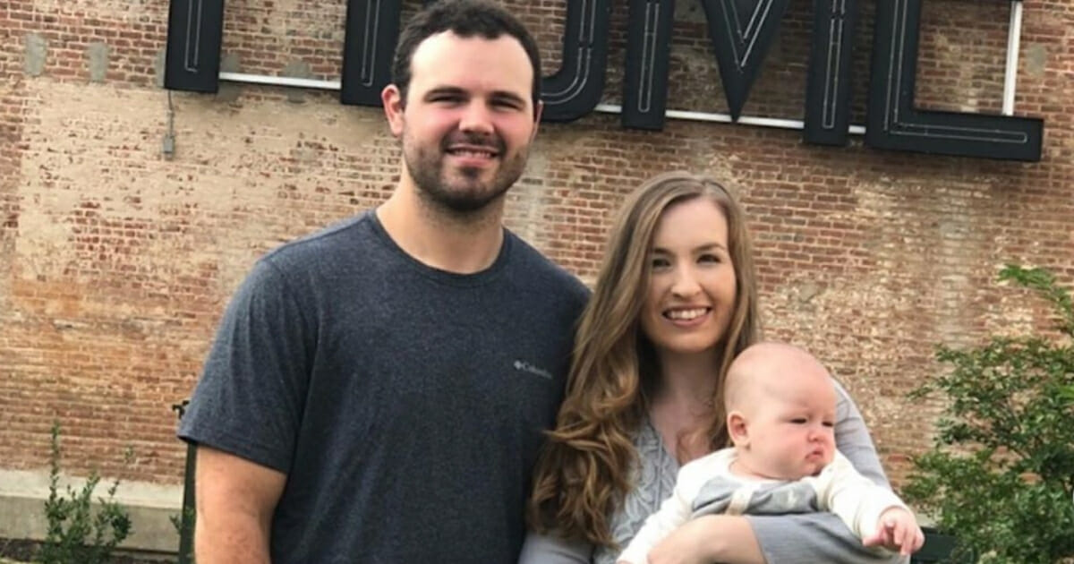 Tampa Bay Rays pitching prospect Blake Bivens with his wife and child.