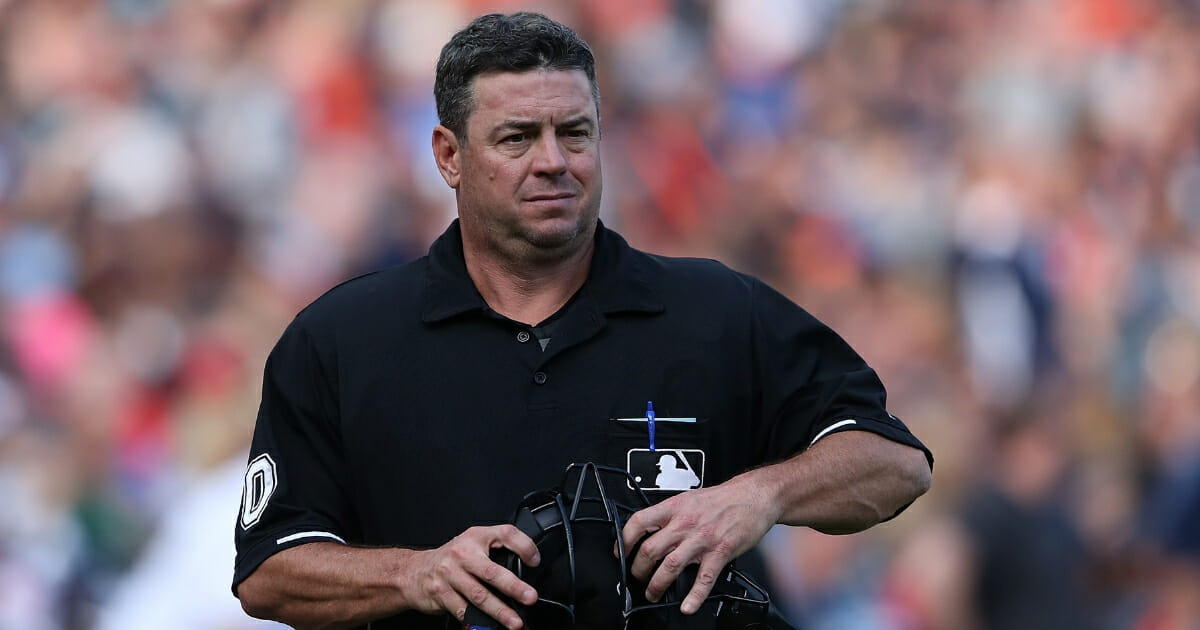 Major League Baseball umpire Rob Drake looks into the dugout during the sixth inning of the game between the Cleveland Indians and the Detroit Tigers on June 13, 2015, at Comerica Park in Detroit, Michigan.