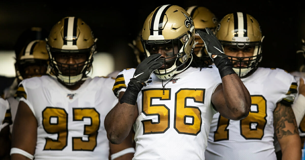 New Orleans Saints linebacker Demario Davis, center, and his teammates prepare to take the field for a game against the Seattle Seahawks at CenturyLink Field.