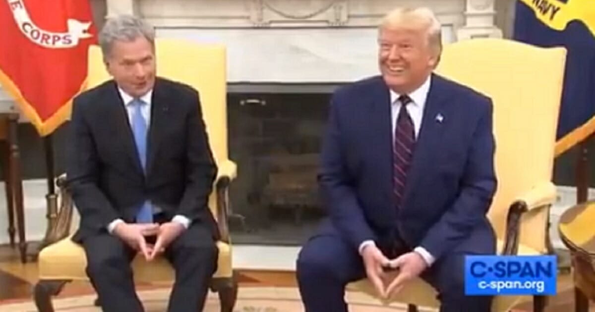 President Donald Trump grins Wednesday during a White House appearance with the president of Finland.