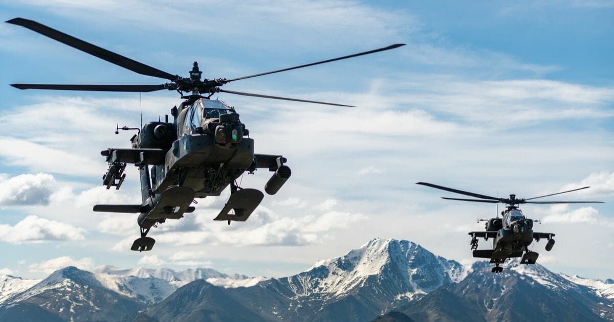 U.S. Army AH-64D Apache Longbow attack helicopters assigned to 1st Battalion, 25th Aviation Regiment Attack Reconnaissance Battalion in flight over an Alaskan mountain range near Fort Wainwright, Alaska, on June 3, 2019.