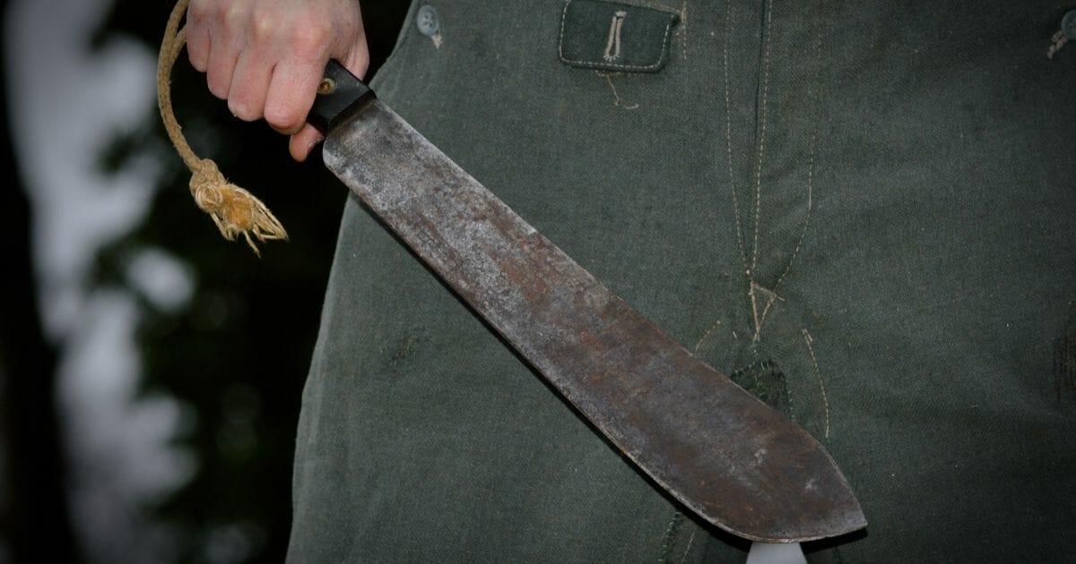 A stock photo of a man holding a machete.