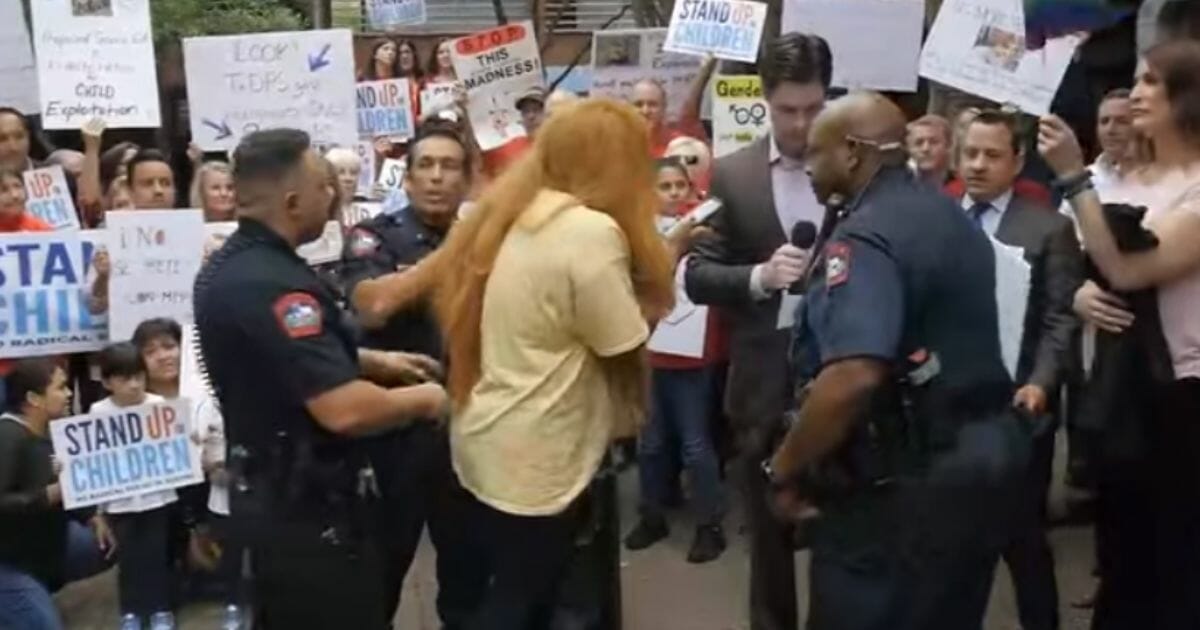 A pro-trans protester seen shouting as cops move in.