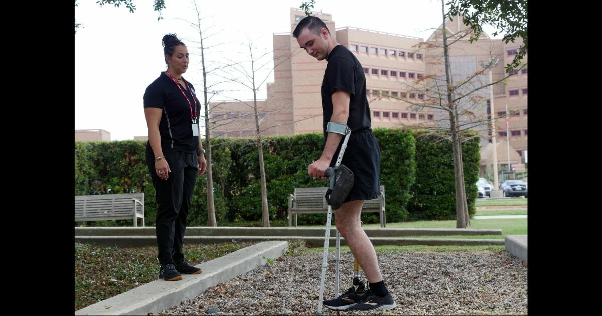 Ezra Maes seen in physical therapy a year after a tank accident took his leg.