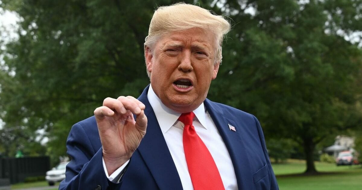 President Donald Trump gestures while taking questions from reporters outside the White House Thursday.