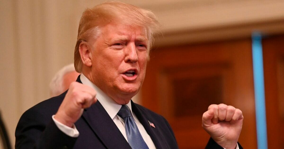 President Donald Trump pumps his fists during a White House event last week.