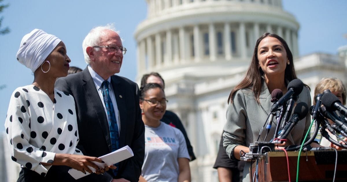 Rep. Alexandria Ocasio-Cortez of New York speaks during a June news conference outlining a "college affordability" plan with fellow Democrats Sen. Bernie Sanders of Vermont and Rep. Ilhan Omar of Minnesota.