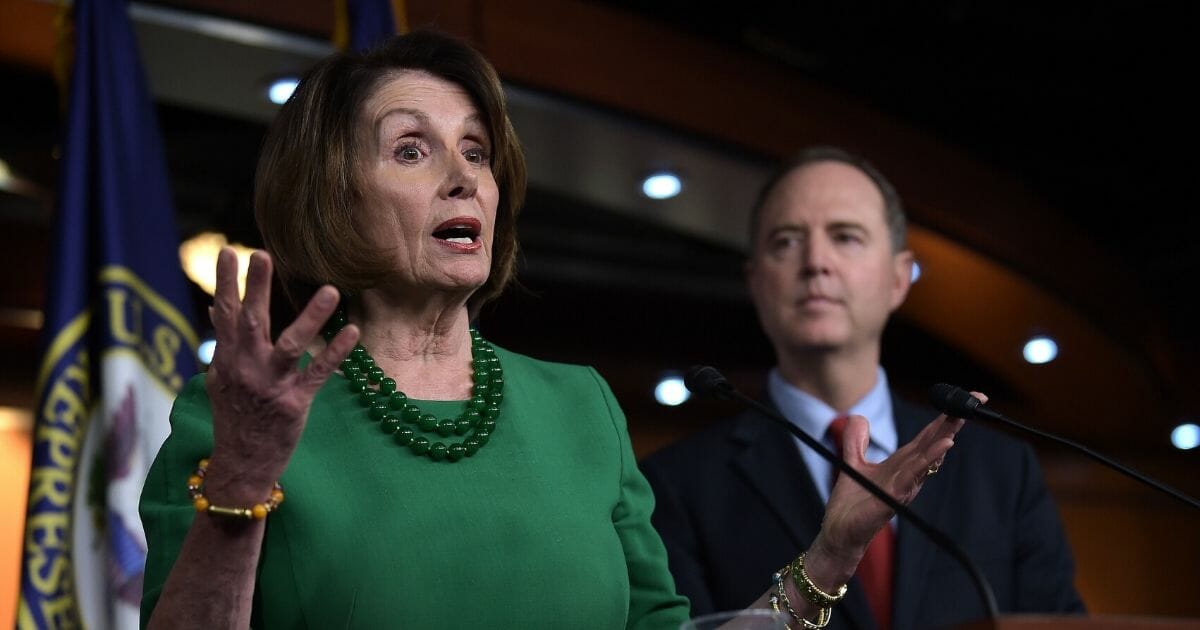House Speaker Nancy Pelosi fields a question during an Oct. 15 news conference while House Intelligence Committee Chairman Adam Schiff listens.