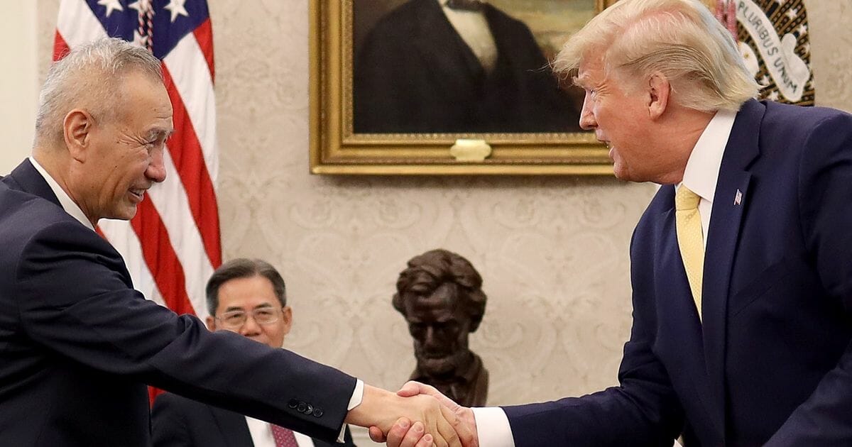 President Donald Trump shakes hands with Chinese Vice Premier Liu He after announcing a "phase one" trade agreement with China in the Oval Office at the White House on Oct. 11, 2019, in Washington, D.C.
