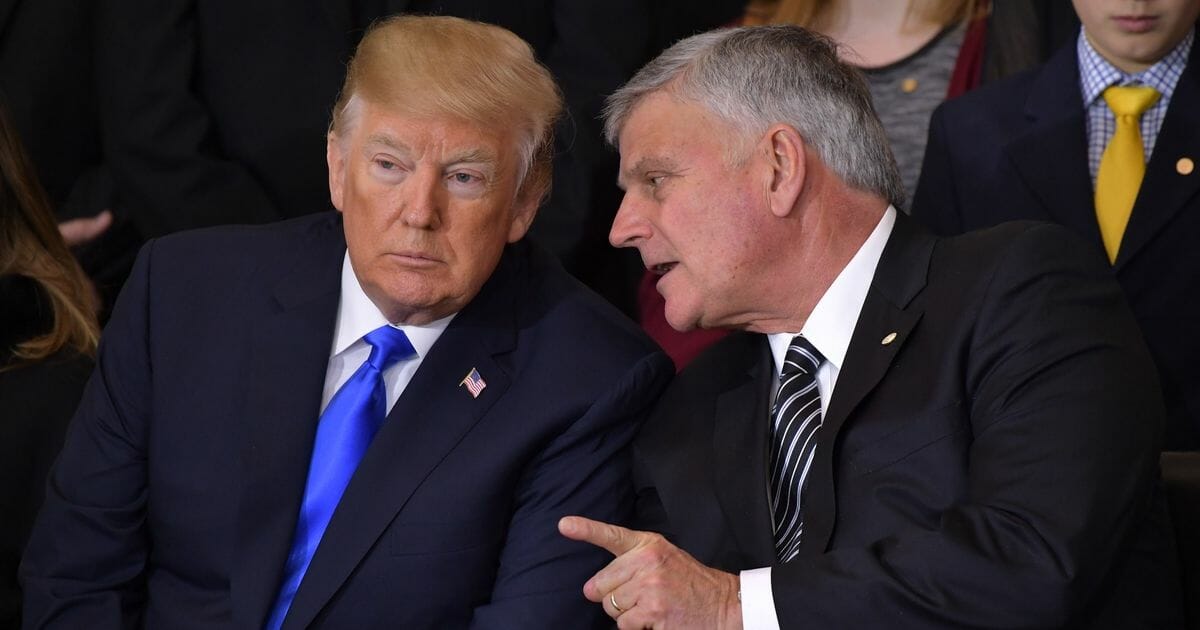 President Donald Trump listens to Rev. Franklin Graham during the memorial service for Graham's father, Rev. Billy Graham, in the Rotunda of the U.S. Capitol on Feb. 28, 2018, in Washington, D.C.