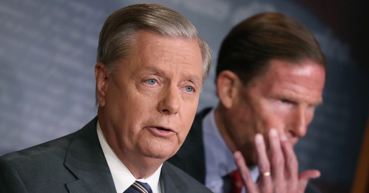 Senate Judiciary Chairman Lindsey Graham of South Carolina speaks while Sen. Richard Blumenthal of Connecticut listens during a news conference to discuss the introduction of bipartisan legislation to impose severe sanctions on Turkish officials in response to their incursion into northern Syria, on Capitol Hill on Oct. 17, 2019, in Washington, D.C.