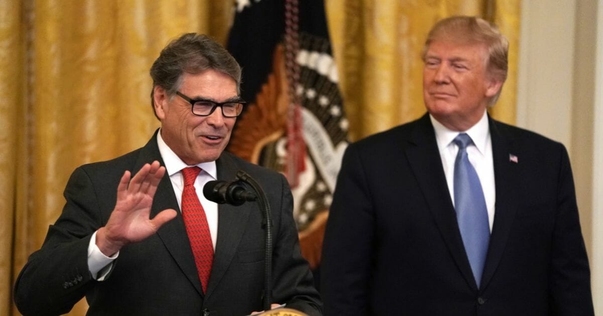 Secretary of Energy Rick Perry speaks as President Donald Trump looks on during an East Room event on the environment July 7, 2019, at the White House in Washington, D.C.