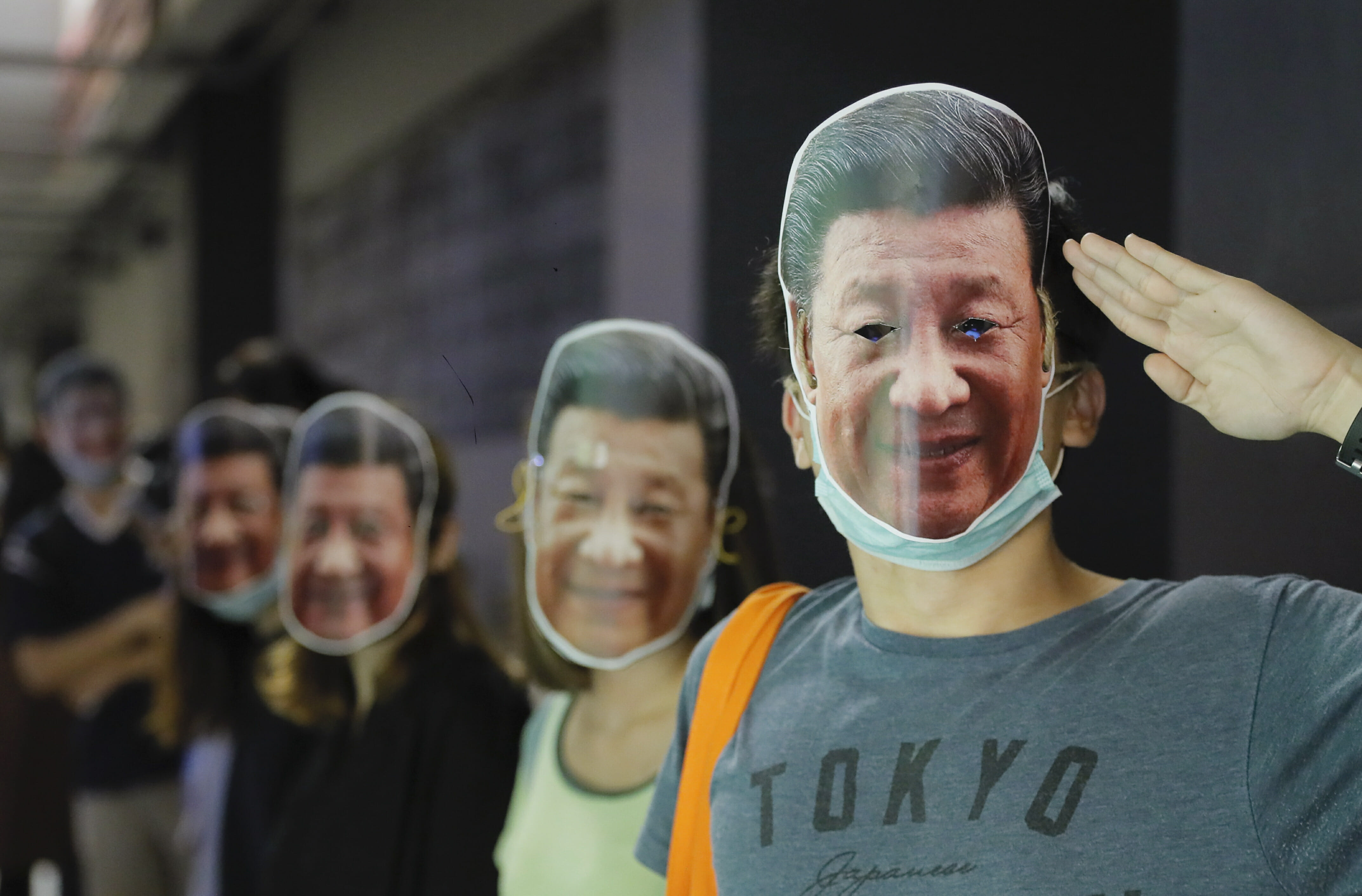 Protesters wear masks of Chinese President Xi Jinping in Hong Kong, Friday, Oct. 18, 2019.