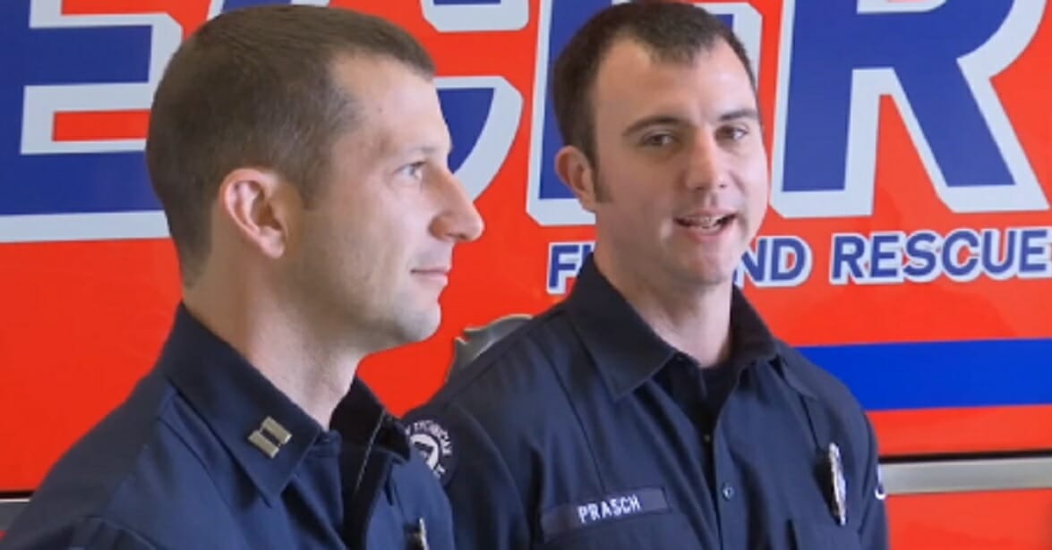 East (Clark) County Fire & Rescue Capt. Matt Hazlett, left, and firefighter John Prasch are interviewed about how they saved an American flag during an Oct. 20 blaze in Washougal, Washington.