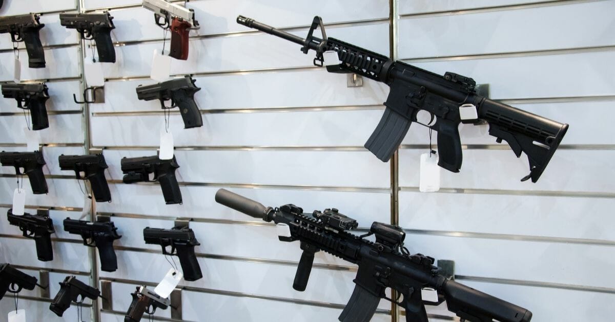 Gun wall rack with rifles and pistol.