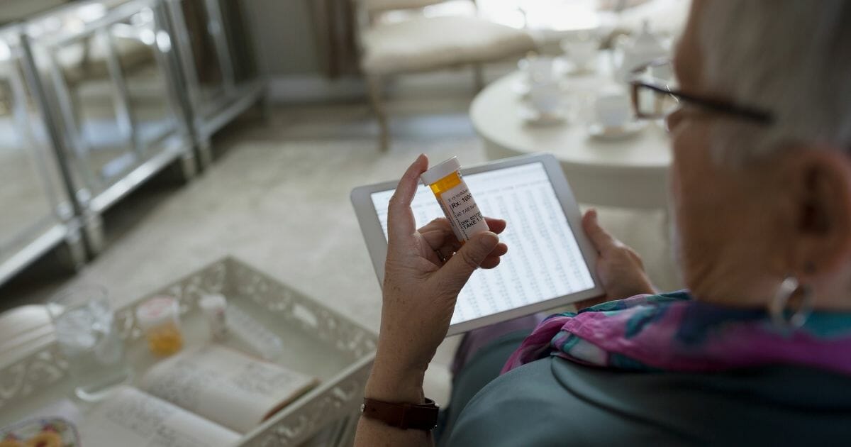 Woman checking prescription label.