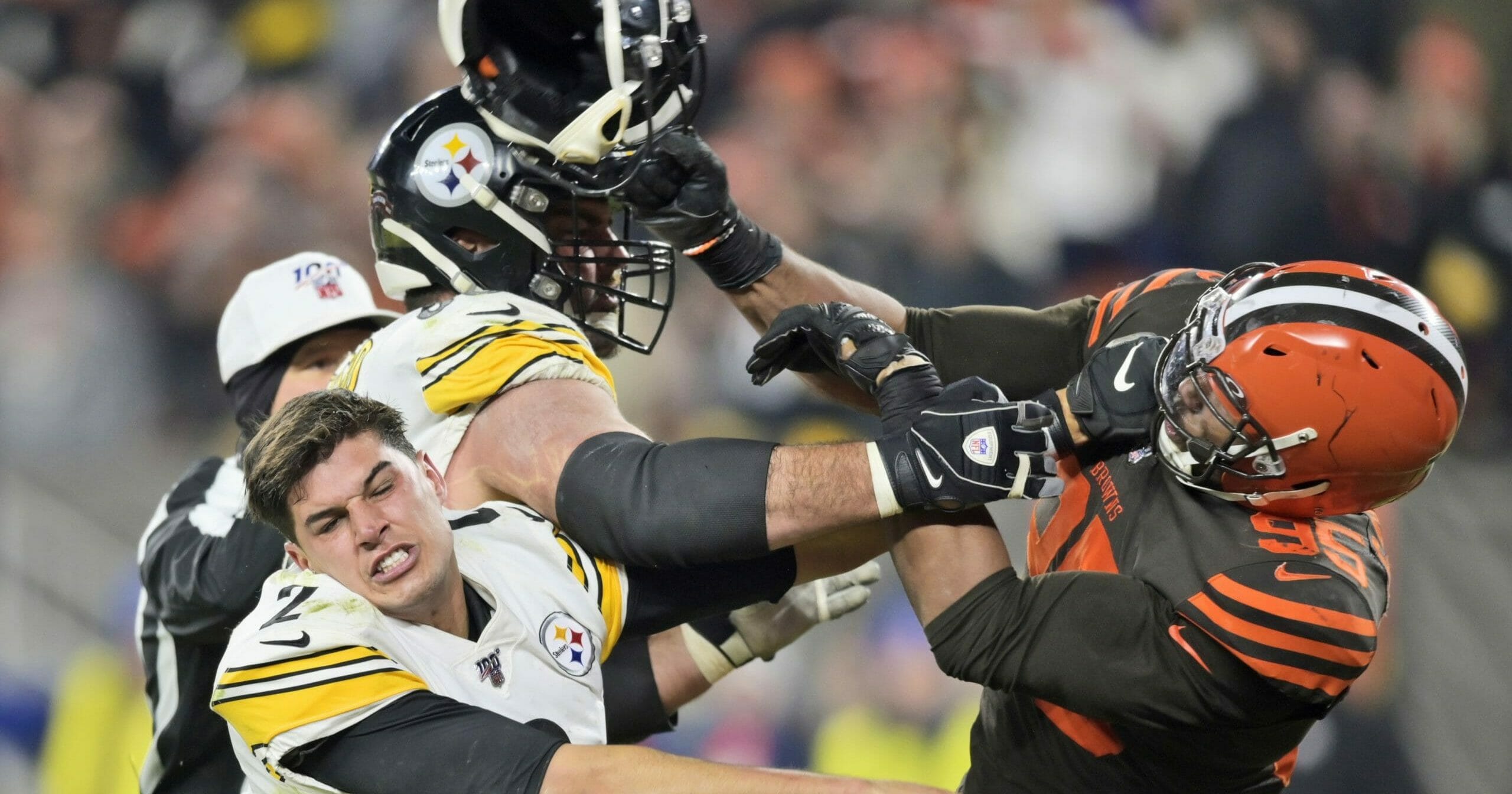 Cleveland Browns defensive end Myles Garrett (95) hits Pittsburgh Steelers quarterback Mason Rudolph (2) with a helmet during the second half of an NFL football game on Nov. 14, 2019, in Cleveland.