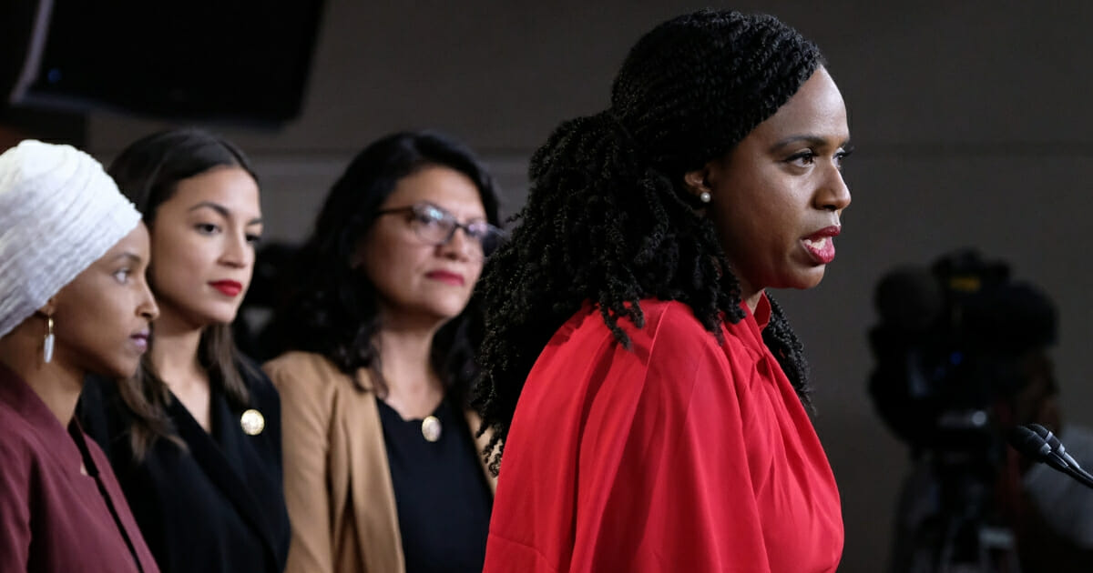 Democratic Rep. Ayanna Pressley of Massachusetts speaks while the other members of the so-called squad -- from left, Reps. Ilhan Omar of Minnesota, Alexandria Ocasio-Cortez of New York and Rashida Tlaib of Michigan -- look on.