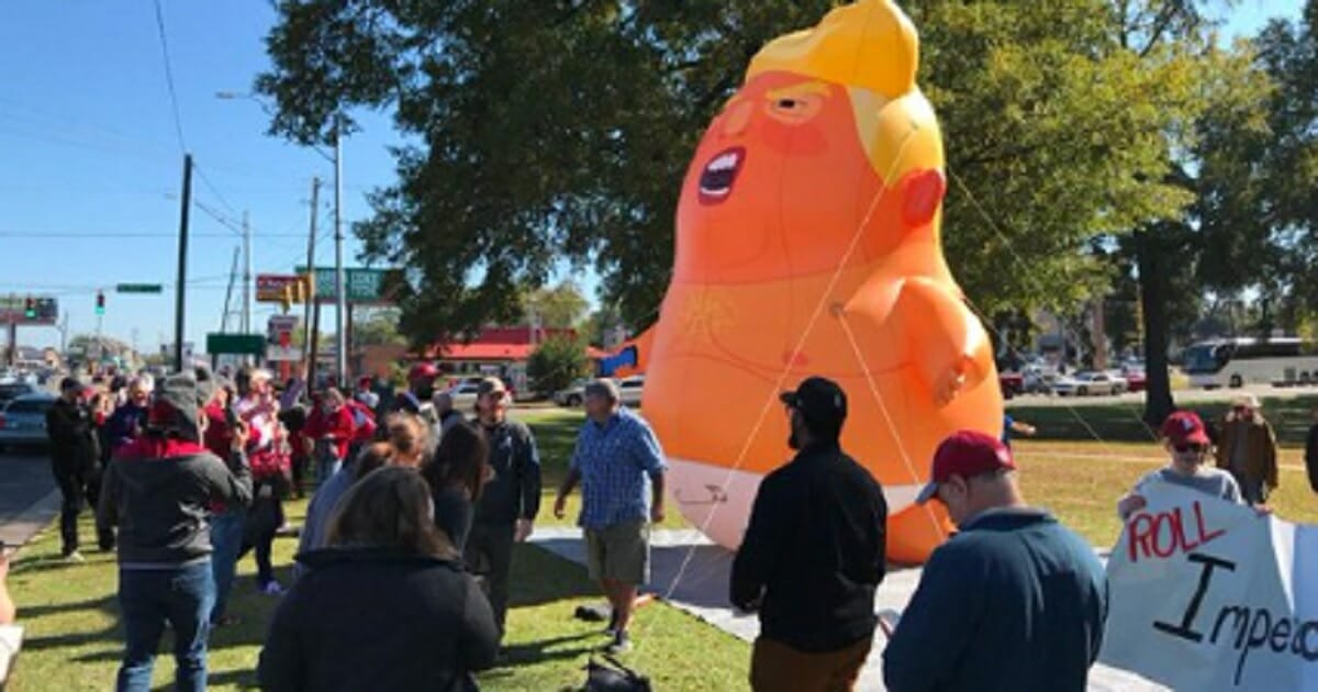A balloon meant to mock president Donald Trump was inflated at Saturday's LSU vs. Alabama football game in Tuscaloosa, but deflated by an abortion opponent with a knife.