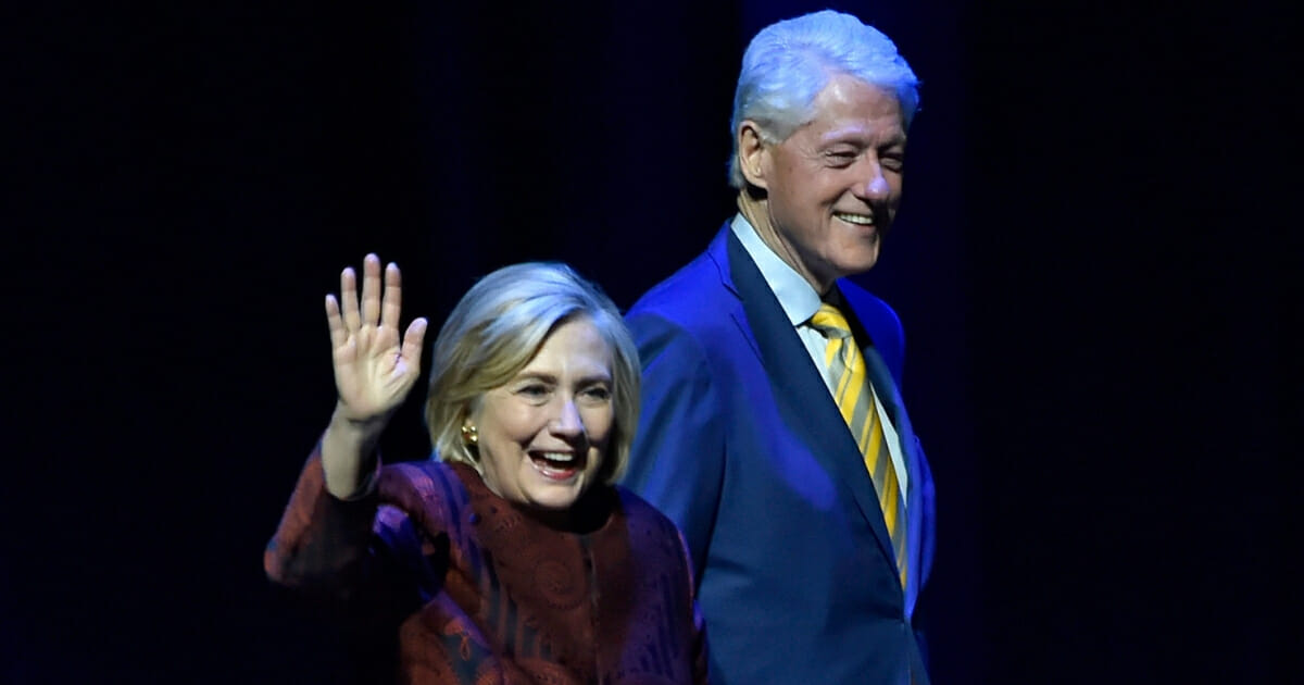 Former Secretary of State Hillary Rodham Clinton, left, and her husband, former President Bill Clinton, walk onstage at Park Theater at Park MGM on May 5, 2019, in Las Vegas, Nevada.