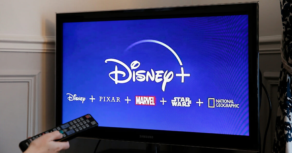 Photo illustration of the Disney Plus logo on a television screen.