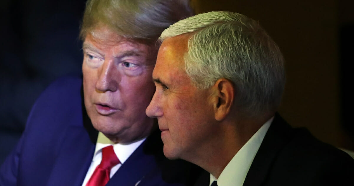 President Donald Trump talks to Vice President Mike Pence during the U.N. Climate Action Summit in New York on Sept. 23, 2019.