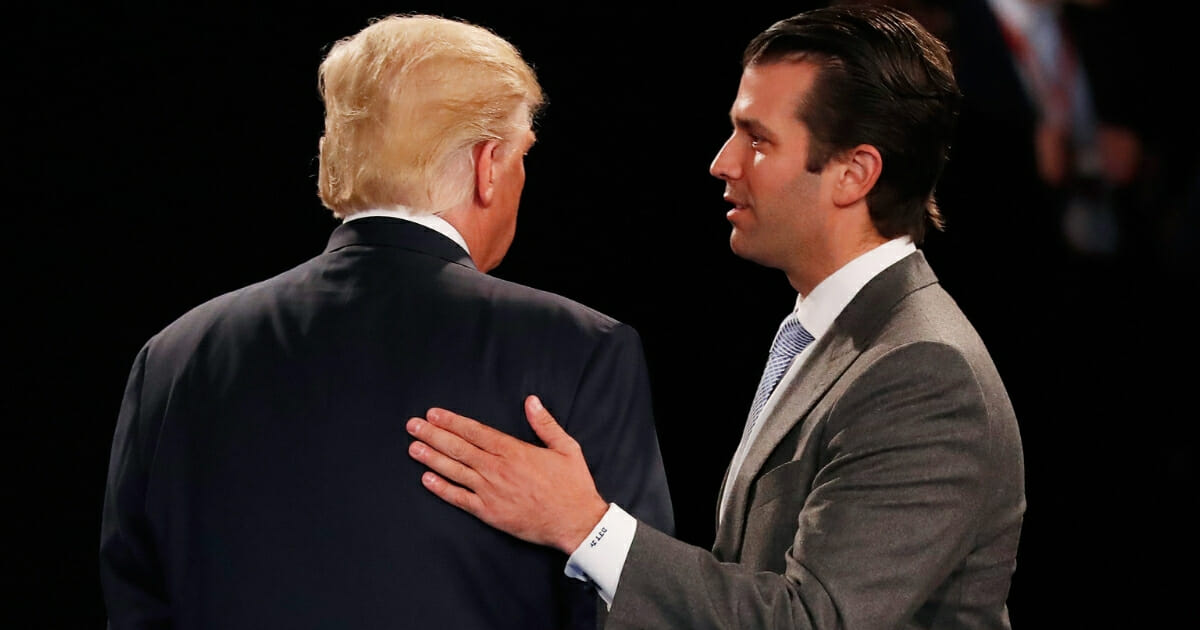 Donald Trump Jr., right, greets his father, then-Republican presidential nominee Donald Trump, during the town hall debate at Washington University on Oct. 9, 2016, in St Louis, Missouri.