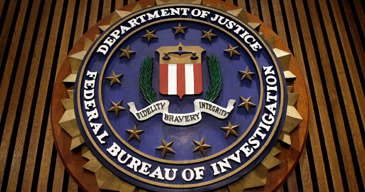 The seal of the FBI hangs in the Flag Room at the bureau's headquarters on March 9, 2007, in Washington, D.C.