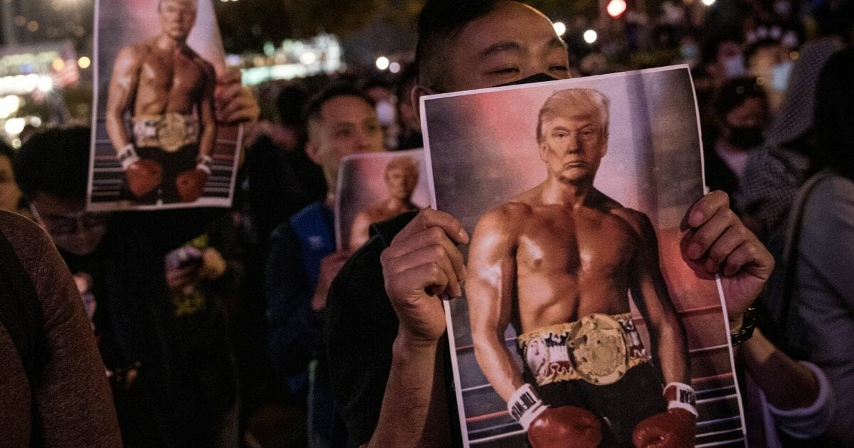 Pro-democracy protesters hold posters of President Donald Trump during a Thanksgiving Day rally at Edinburgh Place on Nov. 28, 2019, in Hong Kong, China.