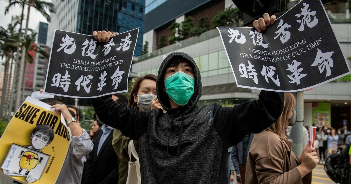 People gather in support of pro-democracy protesters during a lunch break rally in the Kowloon Bay area in Hong Kong on November 26, 2019.