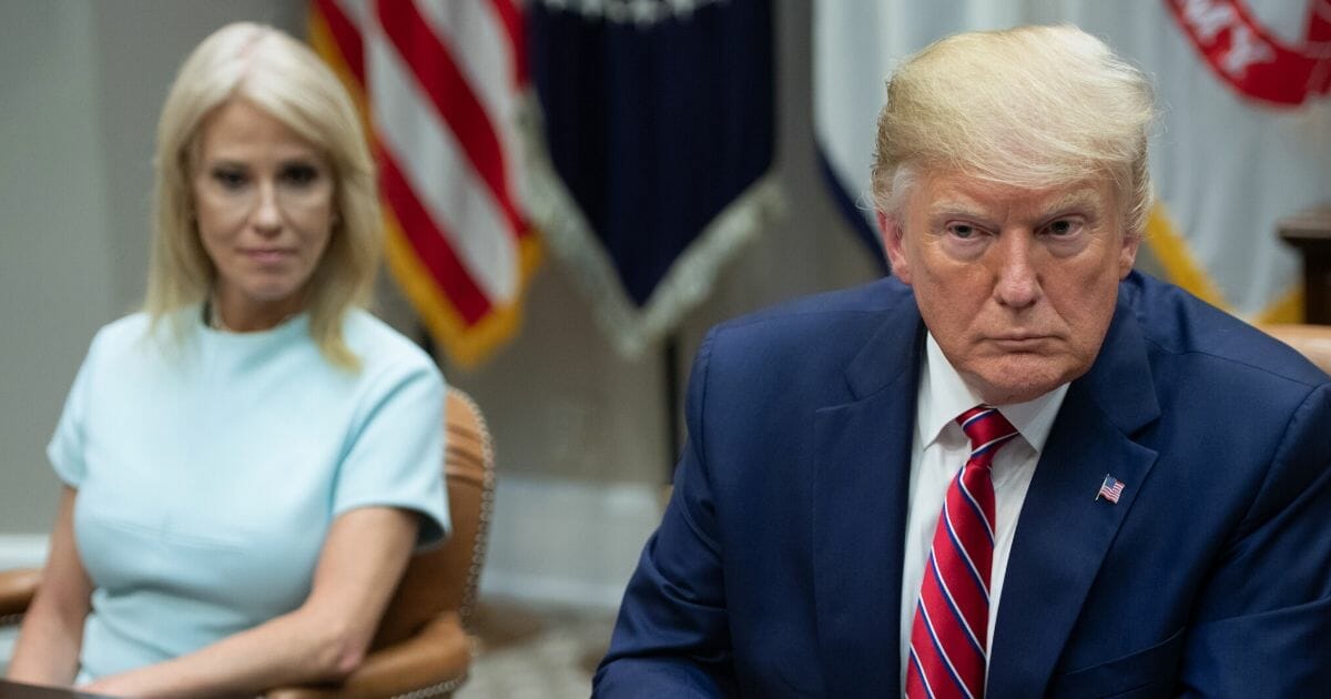 President Donald Trump sits alongside Kellyanne Conway (Left), Counselor to the President, during a meeting on the opioid epidemic in the Roosevelt Room of the White House in Washington, D.C., June 12, 2019