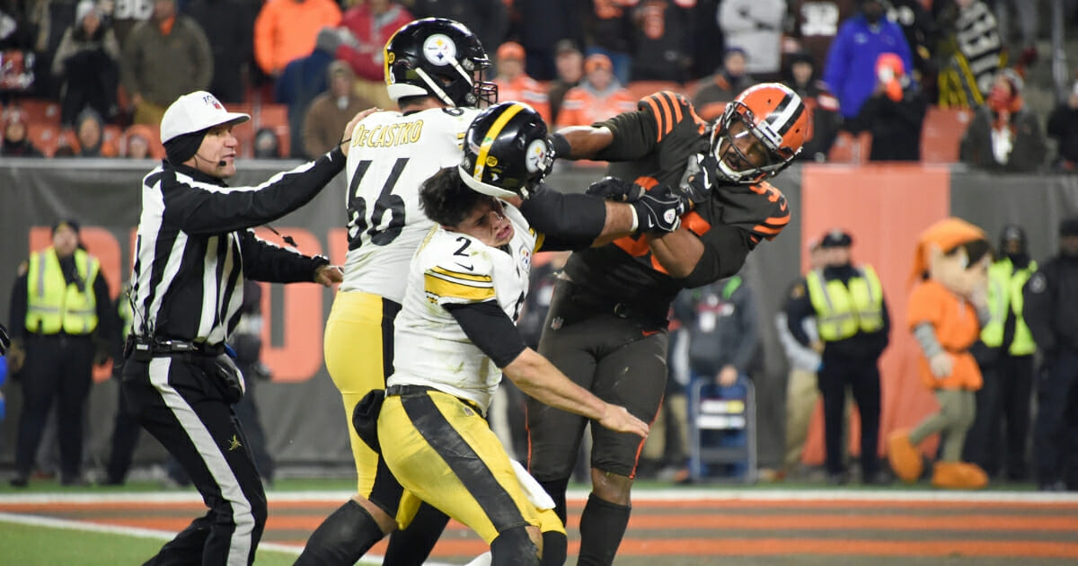 Quarterback Mason Rudolph #2 of the Pittsburgh Steelers gets hit in the head with his own helmet by defensive end Myles Garrett #95 of the Cleveland Browns during the second half at FirstEnergy Stadium on Nov. 14, 2019, in Cleveland, Ohio.