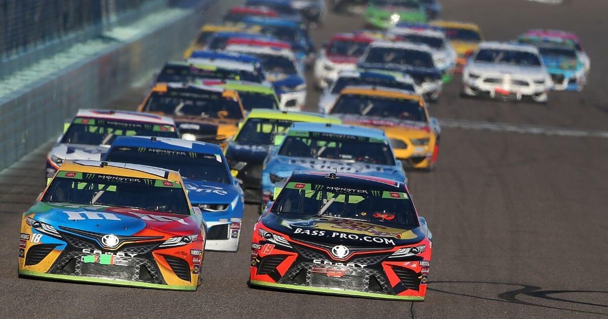 Kyle Busch, driver of the #18 M&M's Toyota, races Martin Truex Jr., driver of the #19 Bass Pro Shops Toyota, during the Monster Energy NASCAR Cup Series Ford EcoBoost 400 at Homestead Speedway on Nov. 17, 2019, in Homestead, Florida.