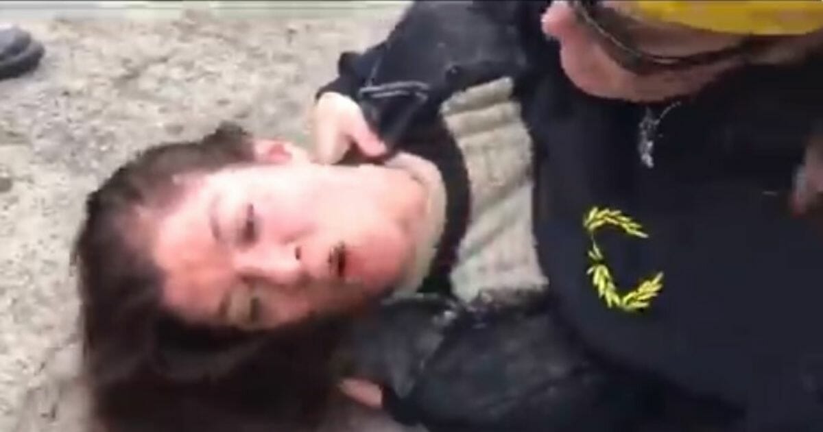 Woman pinned on the ground