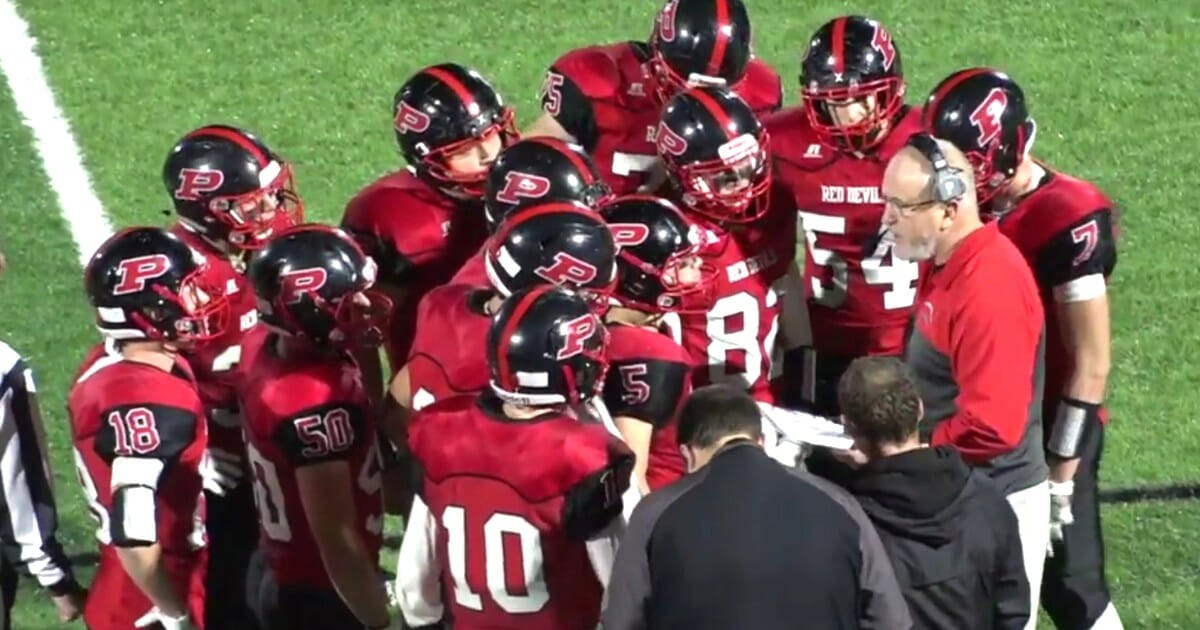 Plainedge High School football coach Rob Shaver talks to his team during its game against South Side.