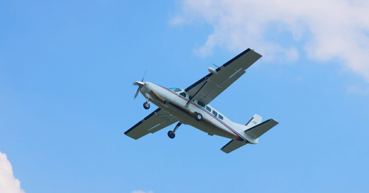 Small turboprop plane against a blue sky