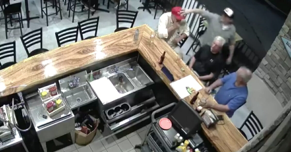 New surveillance video footage shows the moment when a 67-year-old man wearing a "Make America Great Again" hat was assaulted last month in Vero Beach, Florida.