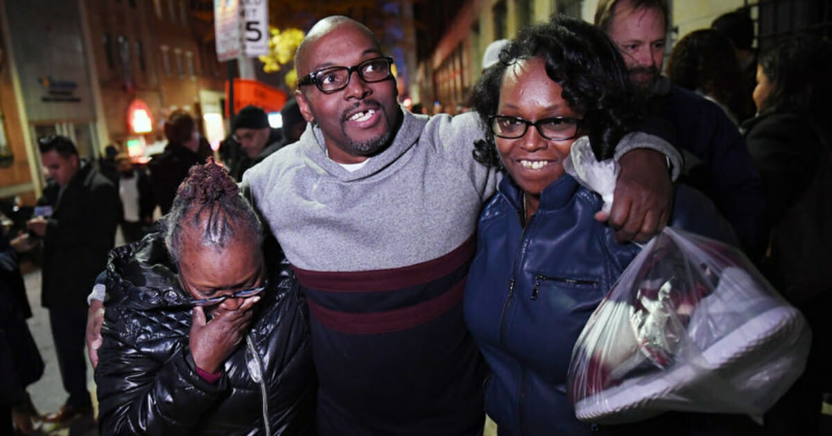 Andrew Stewart walks with his mother and sister Nov. 25, 2019, after he and two other men were exonerated in a 1983 murder for which they were sentenced to life in prison.