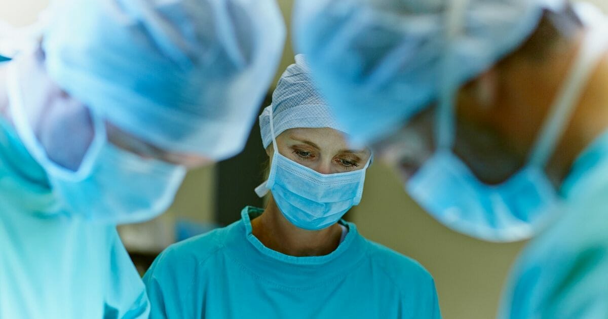 A stock photo of surgeons in an operating room is pictured above.