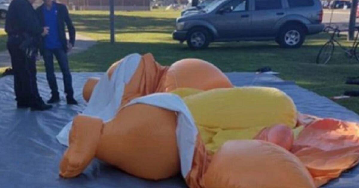 A Donald Trump blimp is deflated on the ground after being stabbed Saturday by a Trump backer in Tuscaloosa, Alabama.