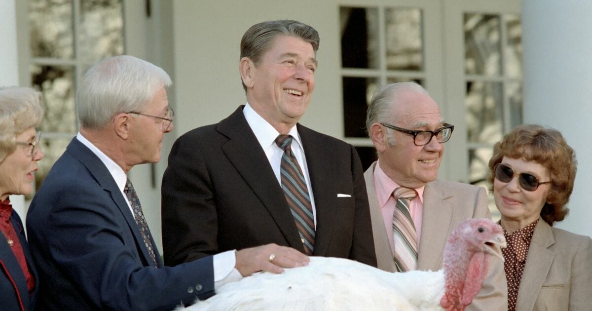 President Ronald Reagan, center, shares a laugh with leaders of the National Turkey Federation and others during the annual National Thanksgiving Turkey Presentation at the White House in Washington on Nov. 21, 1983.