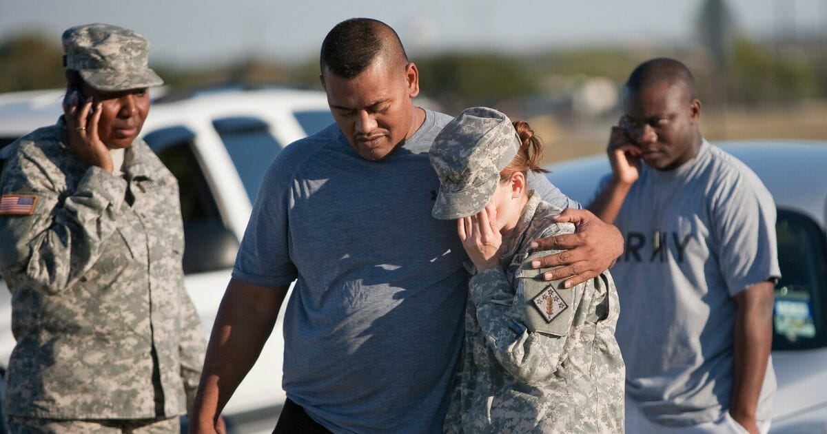 Sgt. Fanuaee Vea puts his arm around Pvt. Savannah Green outside Fort Hood on Nov. 5, 2009, in Killeen, Texas.