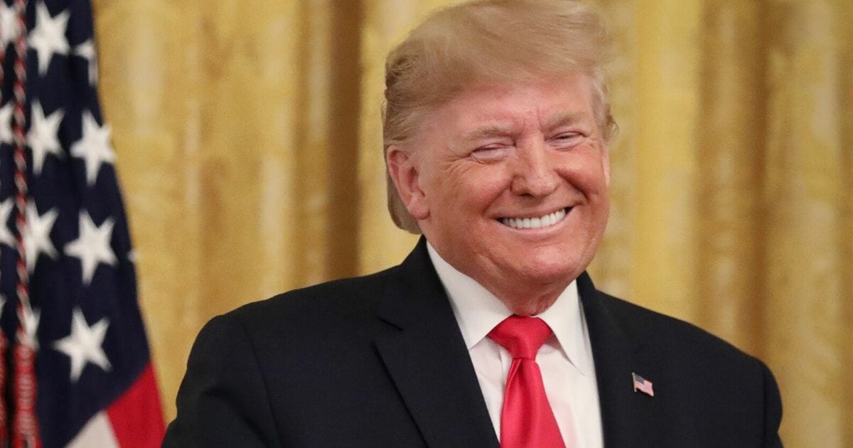 President Donald Trump grins during an event celebrating judicial confirmations last week in the East Room of the White House.