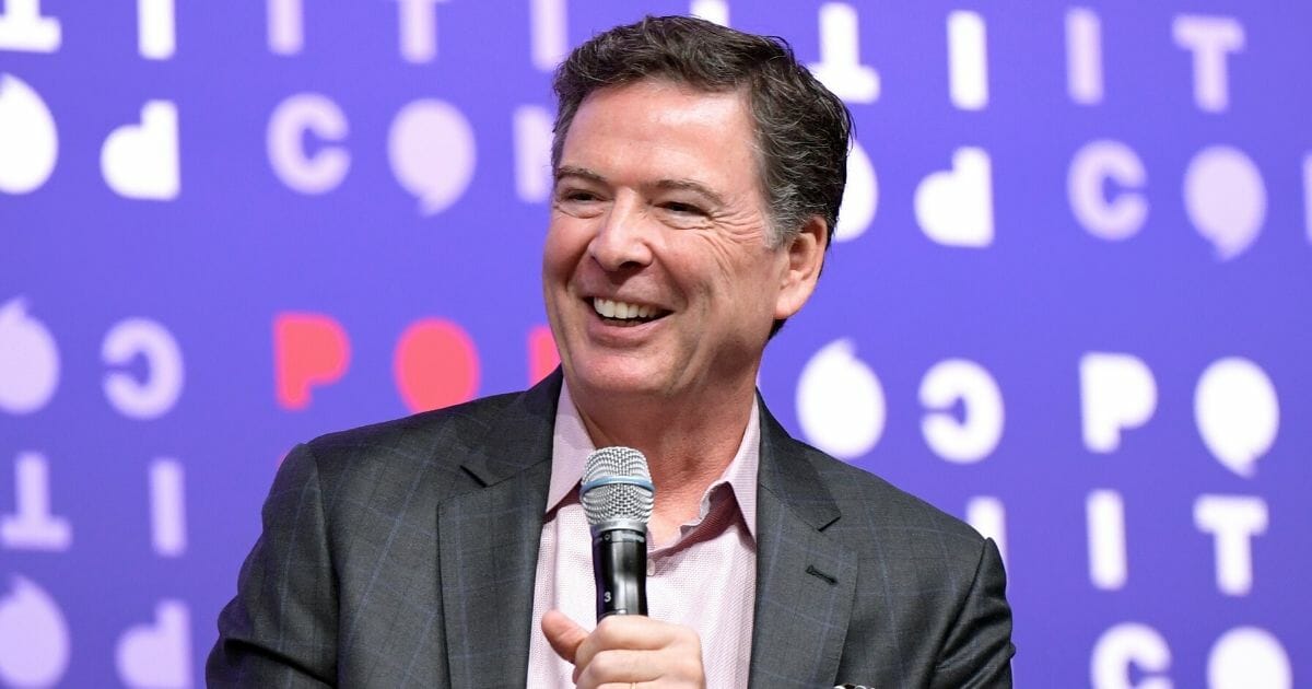 Former FBI Director James Comey laughs during an on-stage interview at Politicon in Nashville, Tennessee, in October.