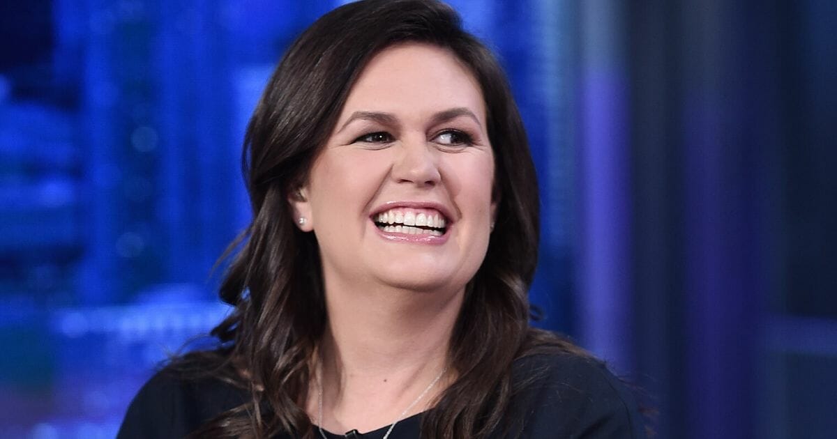 Former White House press secretary Sarah Sanders is pictured grinning in a September file photo.