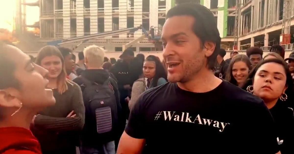 Activist Brandon Straka, the founder of the #WalkAway movement, is harassed by a protester during an event at California State University, Chico on Nov. 20.