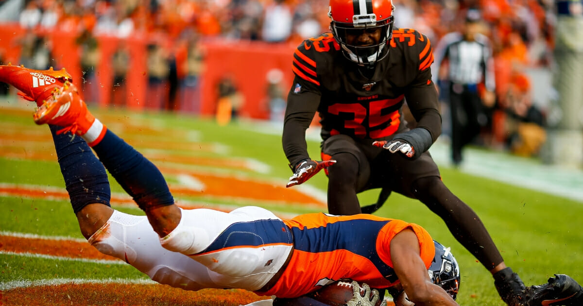 Denver Broncos wide receiver Courtland Sutton catches a touchdown pass as Cleveland Browns safety Jermaine Whitehead defends on the play during the first quarter at Broncos Stadium at Mile High.